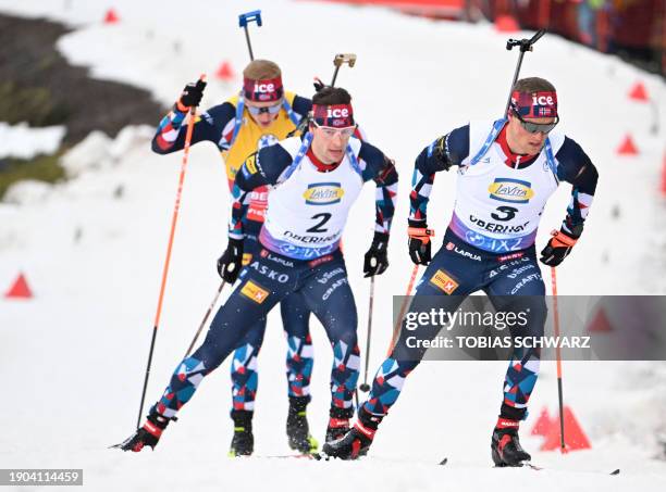 Norway's Endre Stromsheim, Norway's Sturla Laegreid and Norway's Johannes Thingnes Bo compete during the men's 12,5km pursuit event of the IBU...