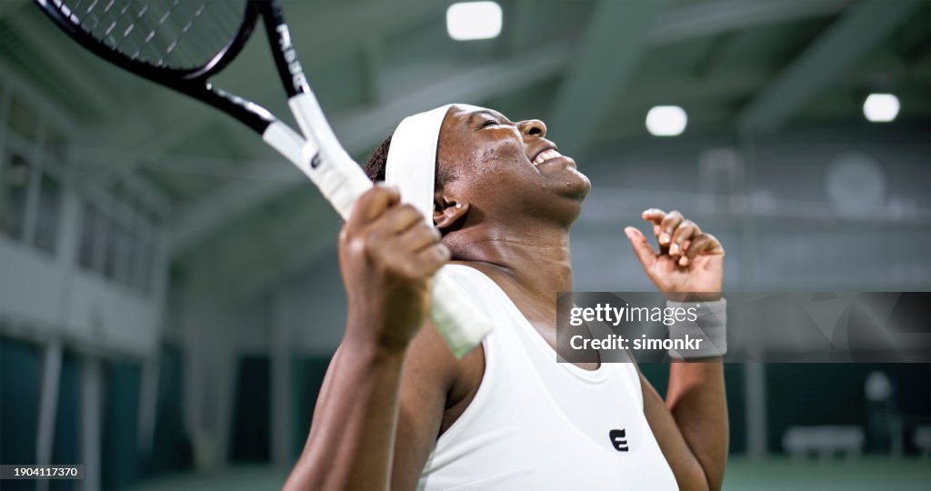 Female tennis player extremely happy about her performance
