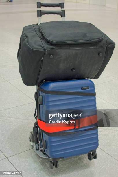rolling suitcase luggage with bag and trolley - strap stock pictures, royalty-free photos & images