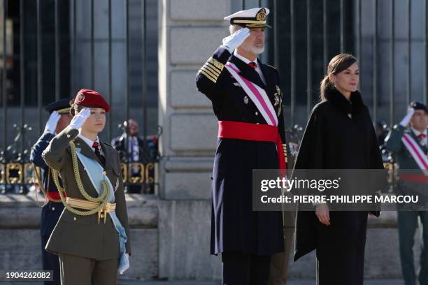 King Felipe VI of Spain and Spanish Crown Princess of Asturias Leonor salute beside Spain's Queen Letizia during the 'Pascua Militar' military...