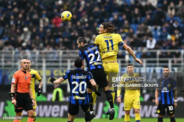 Inter Milan's Armenian midfielder Henrikh Mkhitaryan and Hellas Verona's Bosnian forward Milan Djuric jump for the ball during the Italian Serie A...