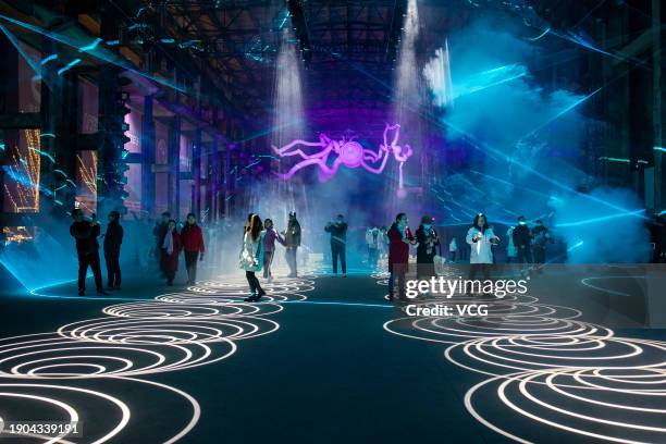 People visit the 2nd International Light and Shadow Art Festival at the Fine Arts Park on January 2, 2024 in Chongqing, China. The 2nd International...