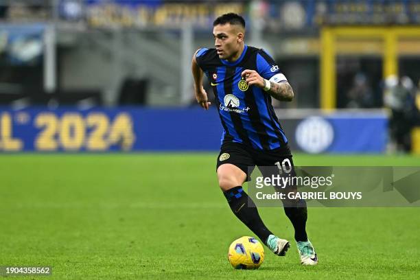 Inter Milan's Argentine forward Lautaro Martinez runs with the ball during the Italian Serie A football match between Inter Milan and Hellas Verona...