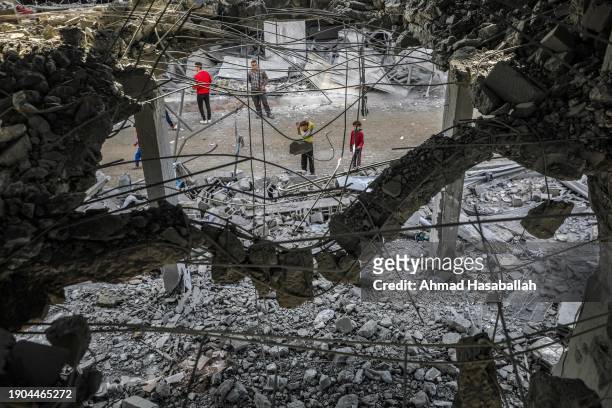 People inspect damage to their homes caused by Israeli air strikes on January 3, 2024 in Rafah, Gaza. More than 21,300 people have been killed in...