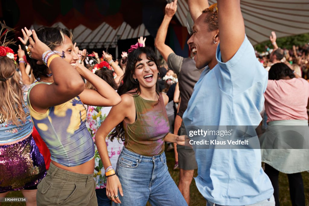 Happy man and women dancing at concert