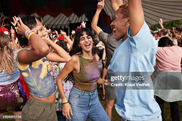 happy man and women dancing at concert - music festival stock pictures, royalty-free photos & images