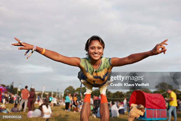 happy woman balancing on boyfriend's legs - human arm stock pictures, royalty-free photos & images