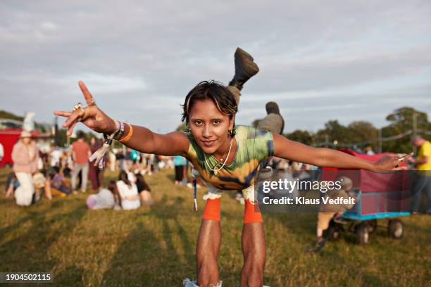 woman balancing with arms outstretched on legs - human arm stock pictures, royalty-free photos & images