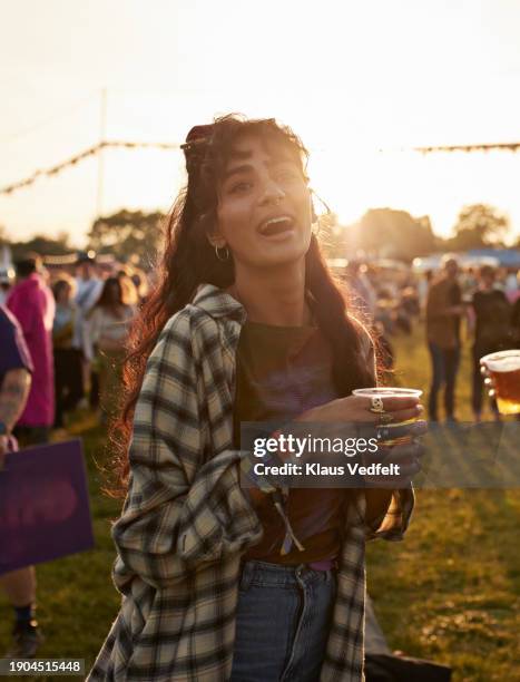 cheerful woman with beer glass at music festival - drinking beer festival stockfoto's en -beelden