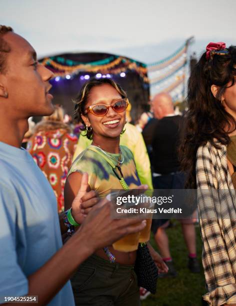 happy woman enjoying music festival with friends - festival goer stock pictures, royalty-free photos & images