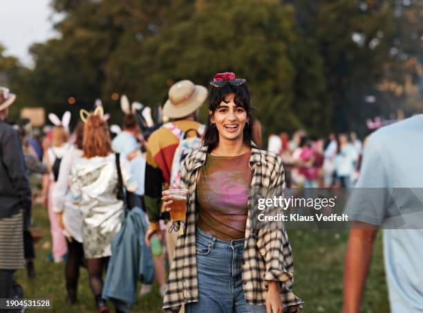 happy woman with beer standing at music festival - one mid adult woman only stock pictures, royalty-free photos & images