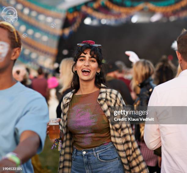 cheerful woman dancing at music festival - one mid adult woman only stock pictures, royalty-free photos & images