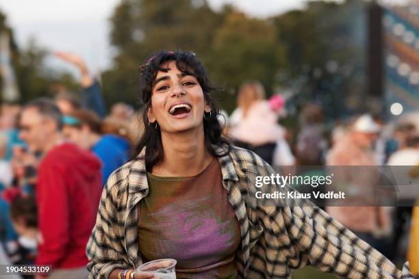 cheerful woman with beer enjoying at music festival - one mid adult woman only stock pictures, royalty-free photos & images