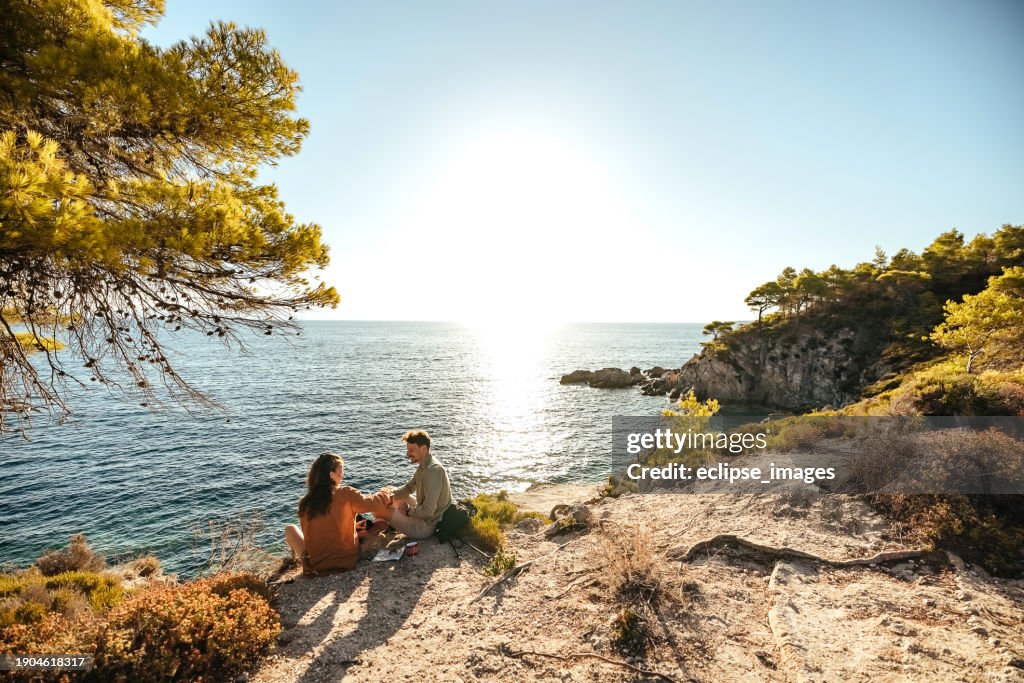 Couple drinking from metal cup