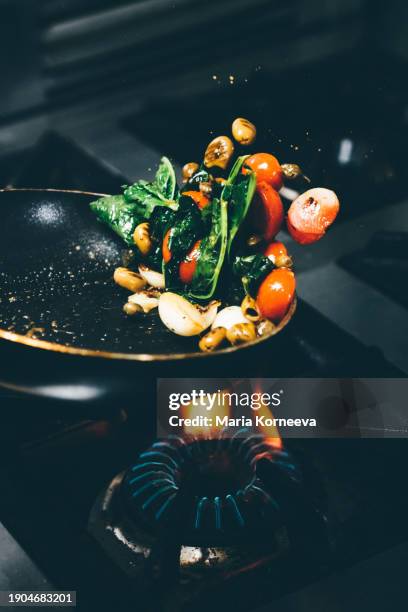 chef frying vegetables in a pan. - i was turning into a vegetable stock pictures, royalty-free photos & images