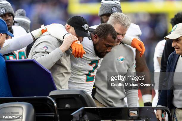 Bradley Chubb of the Miami Dolphins is helped to a cart after an apparent injury during an NFL football game between the Baltimore Ravens and the...