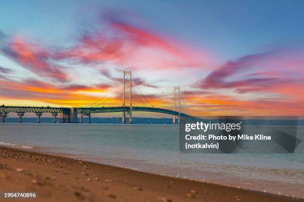 sunset at the mackinac bridge - michigan lakeshore stock pictures, royalty-free photos & images