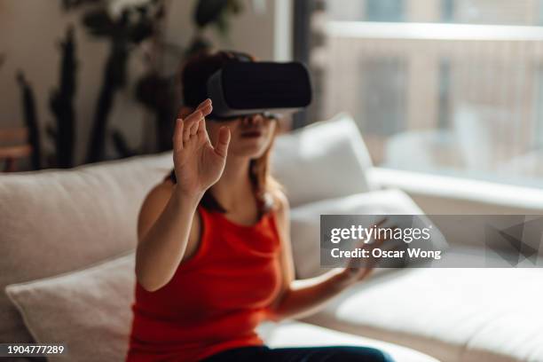 young woman with virtually reality headset immersing in a computer-generated environment - smart glasses eyewear stock pictures, royalty-free photos & images