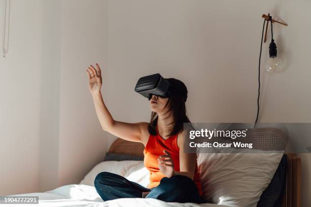 young woman with virtually reality headset immersing in a computer-generated environment - smart glasses eyewear stock pictures, royalty-free photos & images