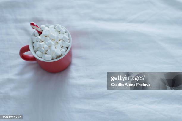 christmas present and mug with cacao  on white bed - big country breakfast stock pictures, royalty-free photos & images