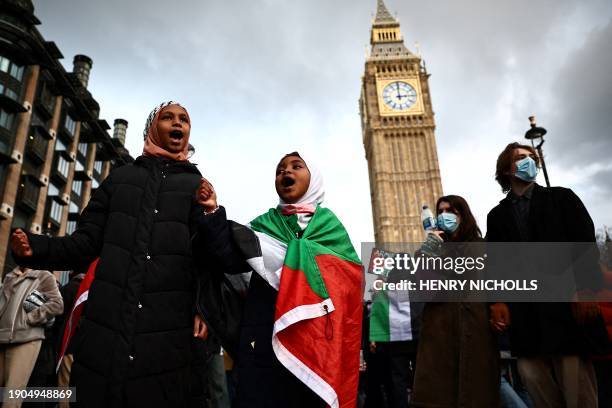 Two young girls, one wrapped in a Palestinian flag, chants slogans as they take part in Pro-Palestinian demonstration, in front of The Elizabeth...