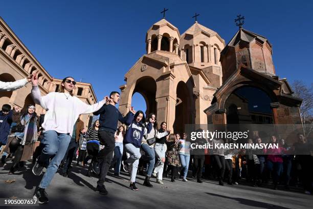 People dance in front of the Saint Anna Church as the Armenian Apostolic Church celebrates Christmas in Yerevan, on January 6, 2024.