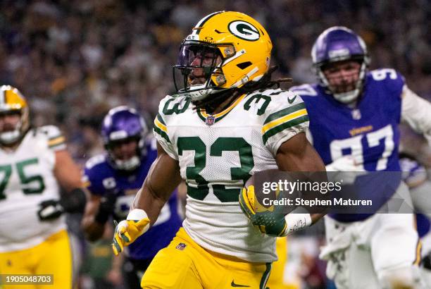 Aaron Jones of the Green Bay Packers carries the ball in the first quarter of the game against the Minnesota Vikings at U.S. Bank Stadium on December...