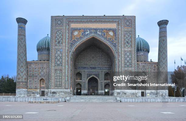 iconic "sher-dor" madrasah facade (1619-1635) on "registan square" in samarkand, uzbekistan, a unesco heritage site - azulejos stock pictures, royalty-free photos & images