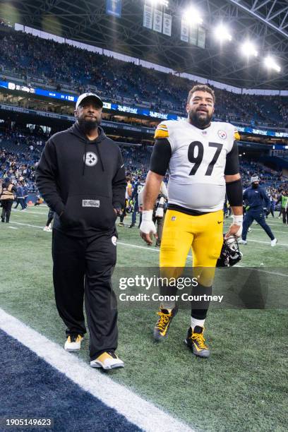 Head coach Mike Tomlin and Cameron Heyward of the Pittsburgh Steelers walk off the field at Lumen Field on December 31, 2023 in Seattle, Washington.