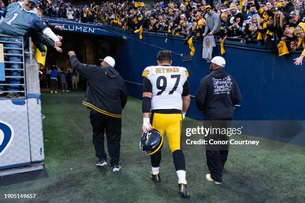 Head coach Mike Tomlin and Cameron Heyward of the Pittsburgh Steelers walk off the field at Lumen Field on December 31, 2023 in Seattle, Washington.