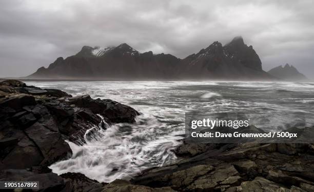 scenic view of sea and mountains against sky - greenwood stock pictures, royalty-free photos & images