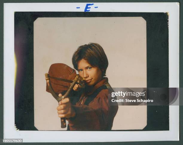 American actor Jonathan Taylor Thomas aims a slingshot for the film 'Man of the House' , Los Angeles, California, 1995.