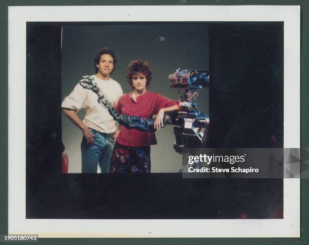 Portrait of American actors Steve Guttenberg and Ally Sheedy , with a robot, for the film 'Short Circuit' , Los Angeles, California, 1986.