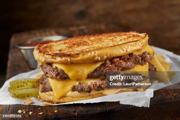 copycat grilled cheese burger on a sesame seed bun - dill pickle stock pictures, royalty-free photos & images