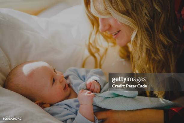 mother and baby together - baby clothes stock pictures, royalty-free photos & images