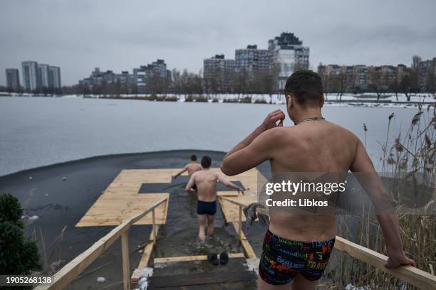 Ukrainians perform the rite of immersion in icy water during Epiphany celebrations on January 6, 2024 in Kyiv, Ukraine. Historically, most Ukrainians...