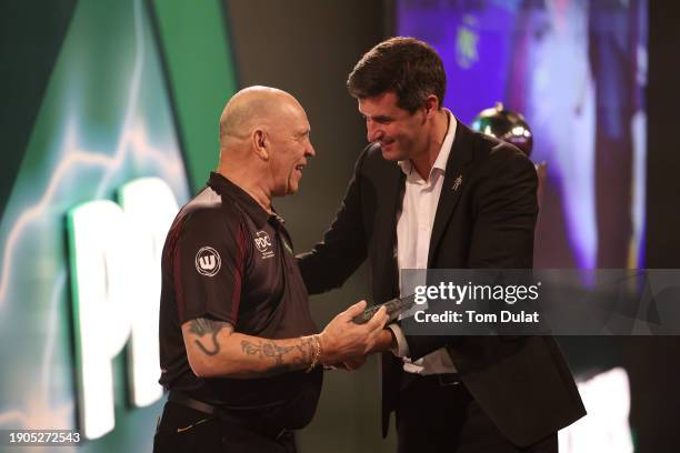 Darts Referee, Russ Bray, is presented with an award by the PDC ahead of his semi-retirement prior to the 2023/24 Paddy Power World Darts...