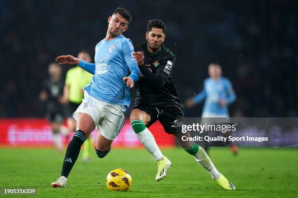 Ayoze Perez of Real Betis Balompie competes for the ball with Carlos Dominguez of RC Celta de Vigo during the LaLiga EA Sports match between RC Celta...