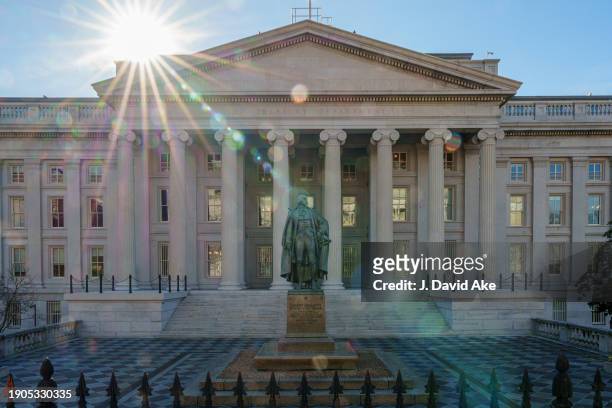 The sun flares over the headquarters of the U.S. Treasury On January 3, 2024 in Washington, DC. A statue of former Secretary of the Treasury Albert...