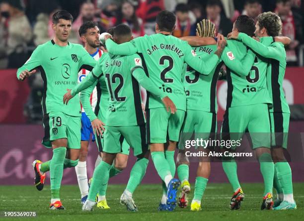 Alvaro Morata of Atletico Madrid celebrates with team mates after scoring their team's first goal during the LaLiga EA Sports match between Girona FC...