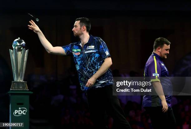 Luke Humphries of England throws during the 2023/24 Paddy Power World Darts Championship Final between Luke Littler of England and Luke Humphries of...