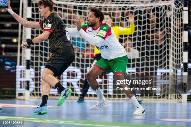 January 2024, Schleswig-Holstein, Kiel: Handball: International match, Germany - Portugal. Germany's Julian Köster and Portugal's Gilberto Duarte...