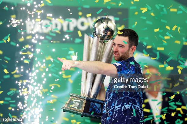 Luke Humphries of England lifts the trophy after winning the 2023/24 Paddy Power World Darts Championship Final between Luke Littler of England and...