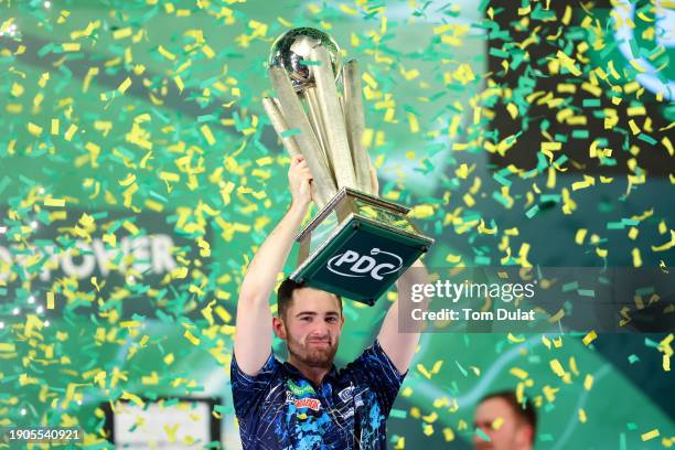 Luke Humphries of England lifts the trophy after winning the 2023/24 Paddy Power World Darts Championship Final between Luke Littler of England and...