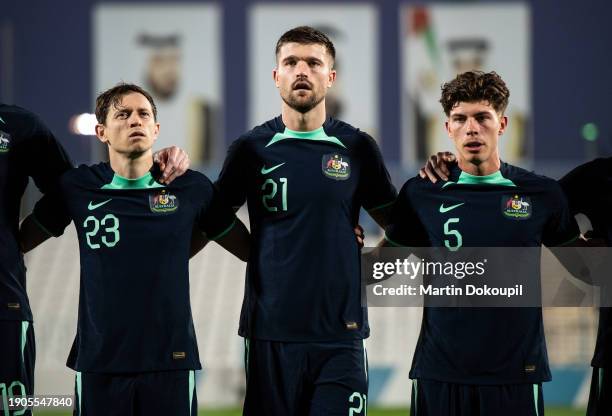 Australia's Craig Alexander Goodwin , Cameron Robert Burgess and Jordan Jacob Bos sing the national anthem ahead of the international friendly...