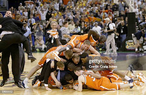 The Syracuse team celebrates at center court after defeating Kansas during the championship game of the NCAA Men's Final Four Tournament on April 7,...