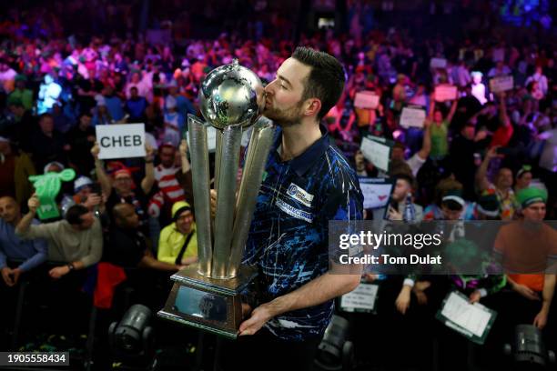 Luke Humphries of England poses for a photo with the trophy after winning the 2023/24 Paddy Power World Darts Championship Final against Luke Littler...