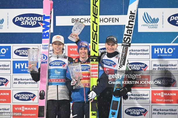 Second placed Japan's Ryoyu Kobayashi, first placed Austria's Stefan Kraft and third placed Slovenia's Anze Lanisek react with their trophies on the...