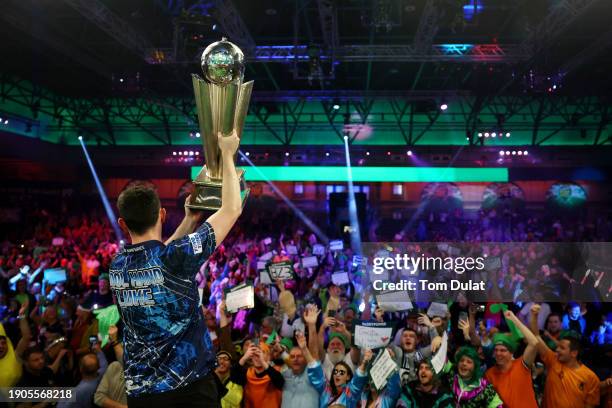 Luke Humphries of England celebrates victory with the trophy after winning the 2023/24 Paddy Power World Darts Championship Final against Luke...