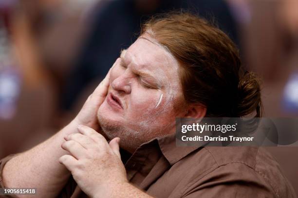 Cricket fan applies sunscreen before the start of play on day two of the Men's Third Test Match in the series between Australia and Pakistan at...